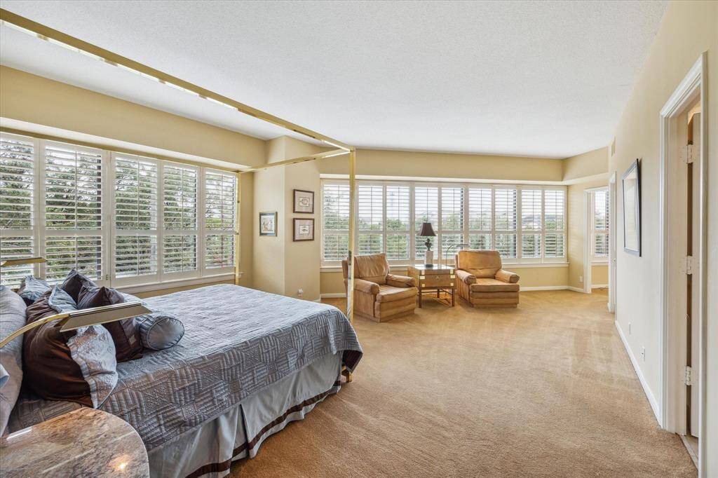 Primary bedroom is 17x27 and accommodates king size bed plus seating area.  Wood shutters on all windows.  Opening at end of room on the right opens into a home office, nursery or closet space.