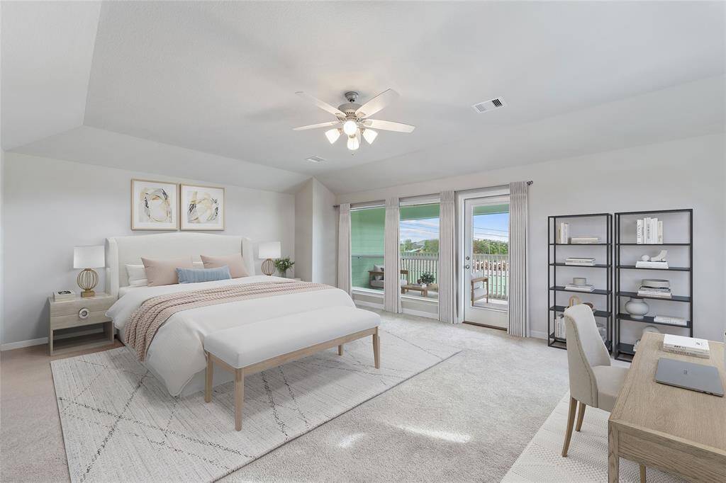 Experience luxury in the spacious primary suite, which includes direct access to a private balcony. Virtually staged.