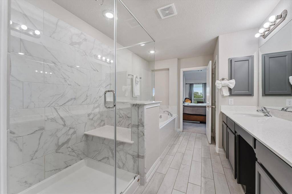 Enjoy the comfort of a spacious shower equipped with a built-in seat in the primary bath.