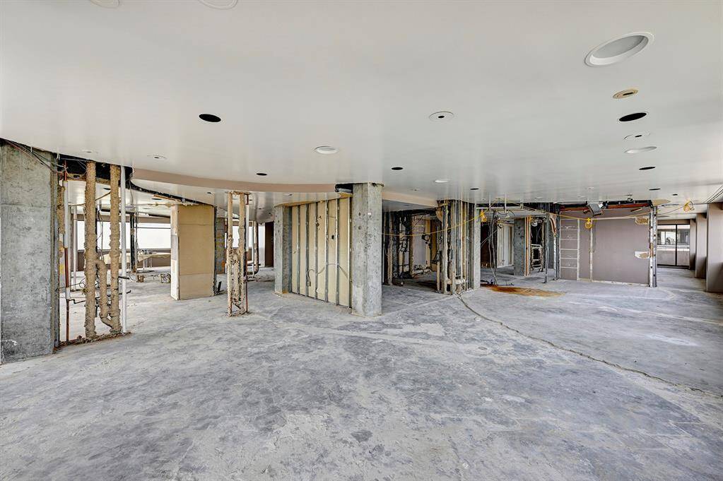 Discover a renovator's dream with this expansive open-plan space, primed for your creative vision. With its clean slate of bare studs and concrete floors, this is an ideal canvas for crafting your interior masterpiece.