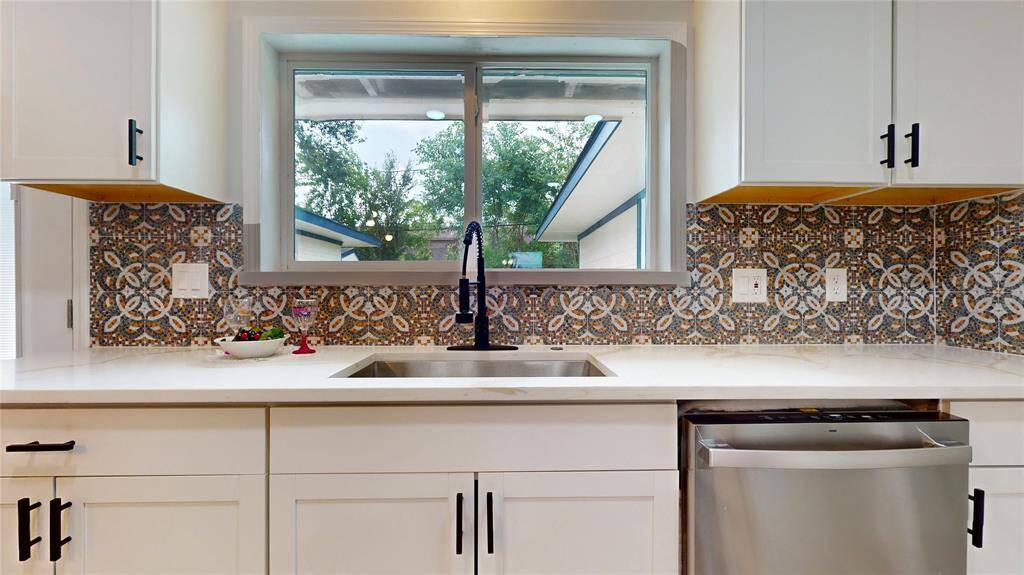 A large window brings in natural light, enhancing the airy and clean aesthetic.