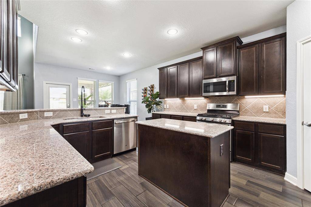 Generous Counter space, Granite Countertops and Backsplash Lighting.