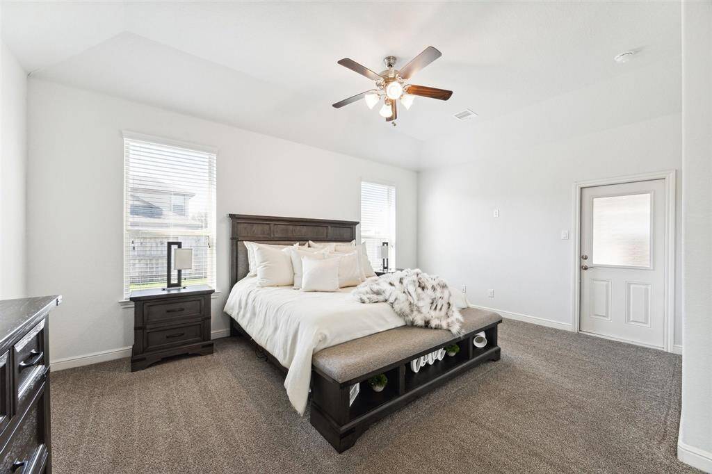 Step out from the primary bedroom to your personal sanctuary via a private door to back patio.