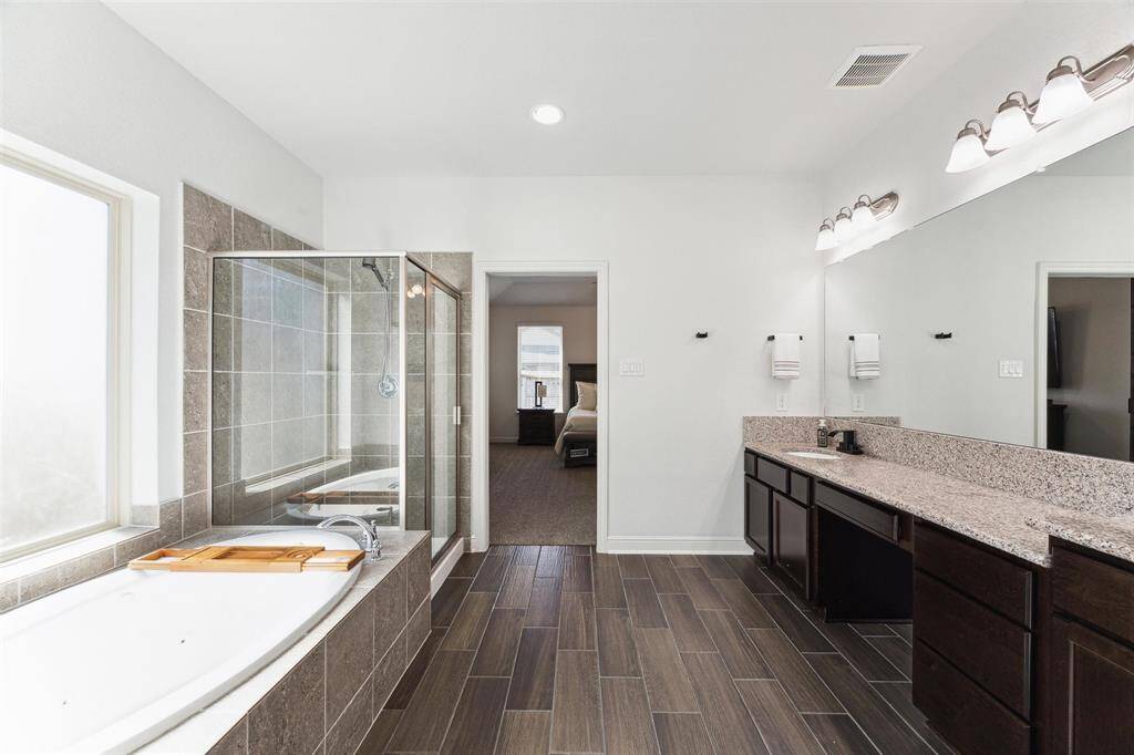 Primary Bathroom Shower and Separate Jetted Bathtub.