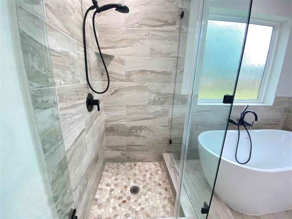 Tiled shower with frameless glass door