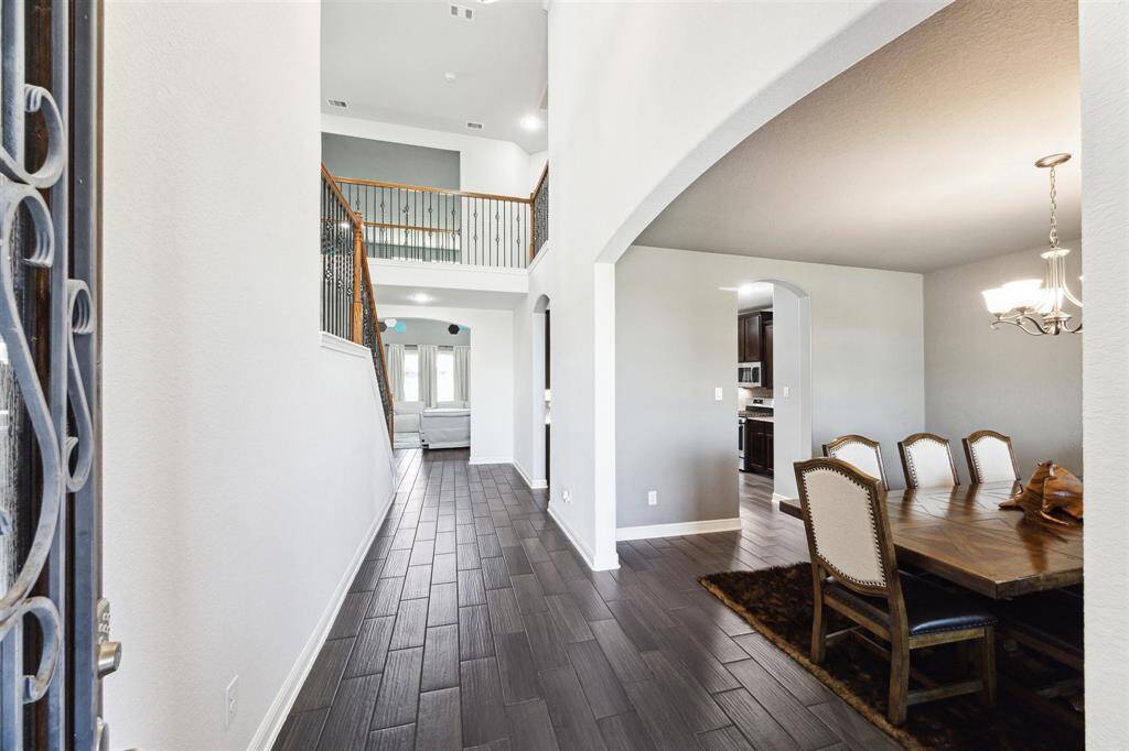 Wood-like Tile Flooring, High Ceilings and Bright Natural Light.