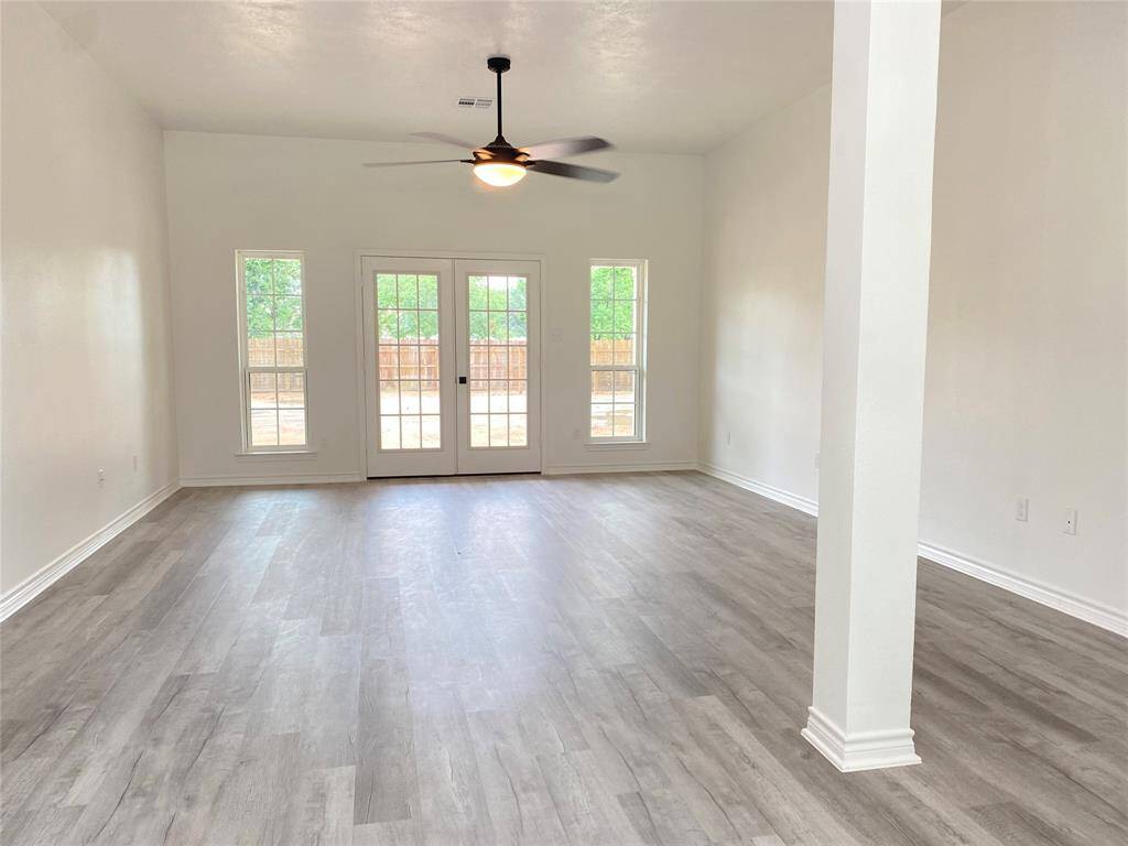 Living room with high ceiling and large ceiling fan