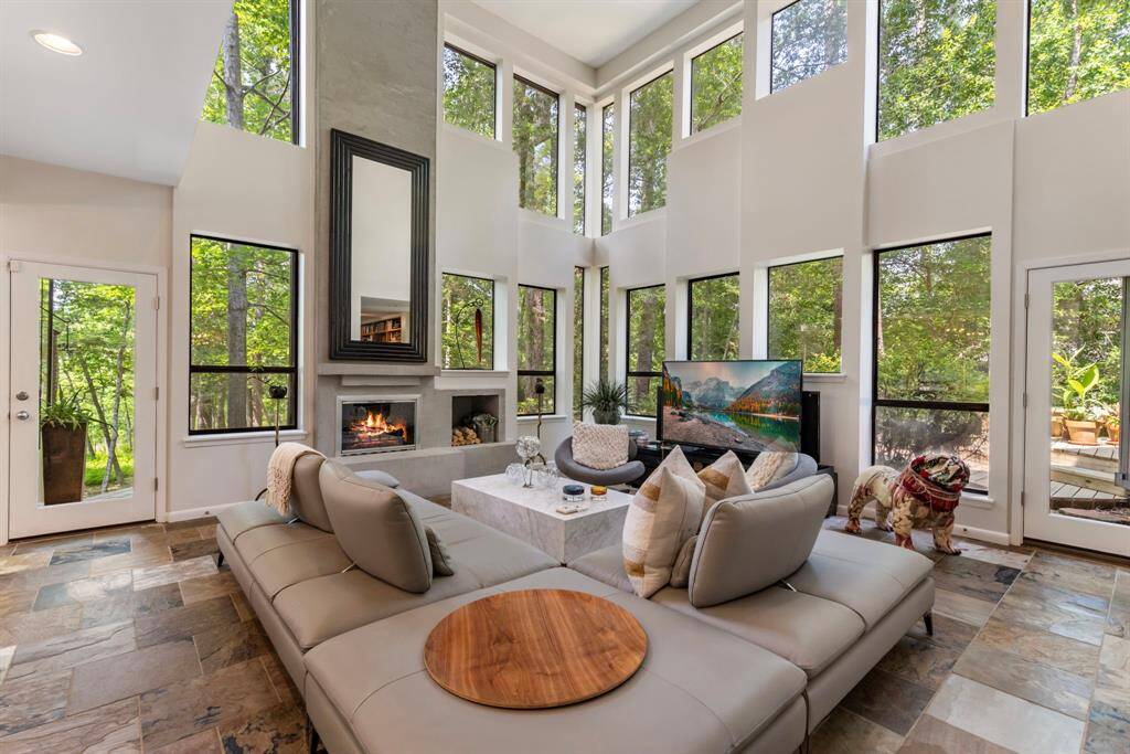 Incredible architectural floor to ceiling windows frame views of the properties natural surroundings.