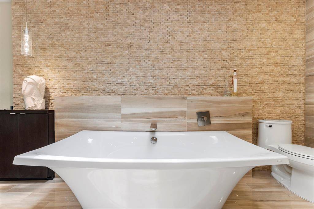 Stacked stone wall and tile back splash create an inviting, earthy backdrop.