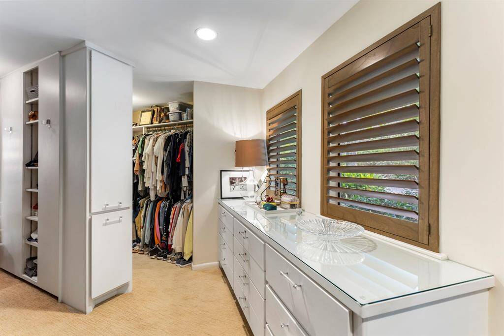 An expansive custom closet that is highly efficient, balancing generous storage, privacy and a beautiful setting.