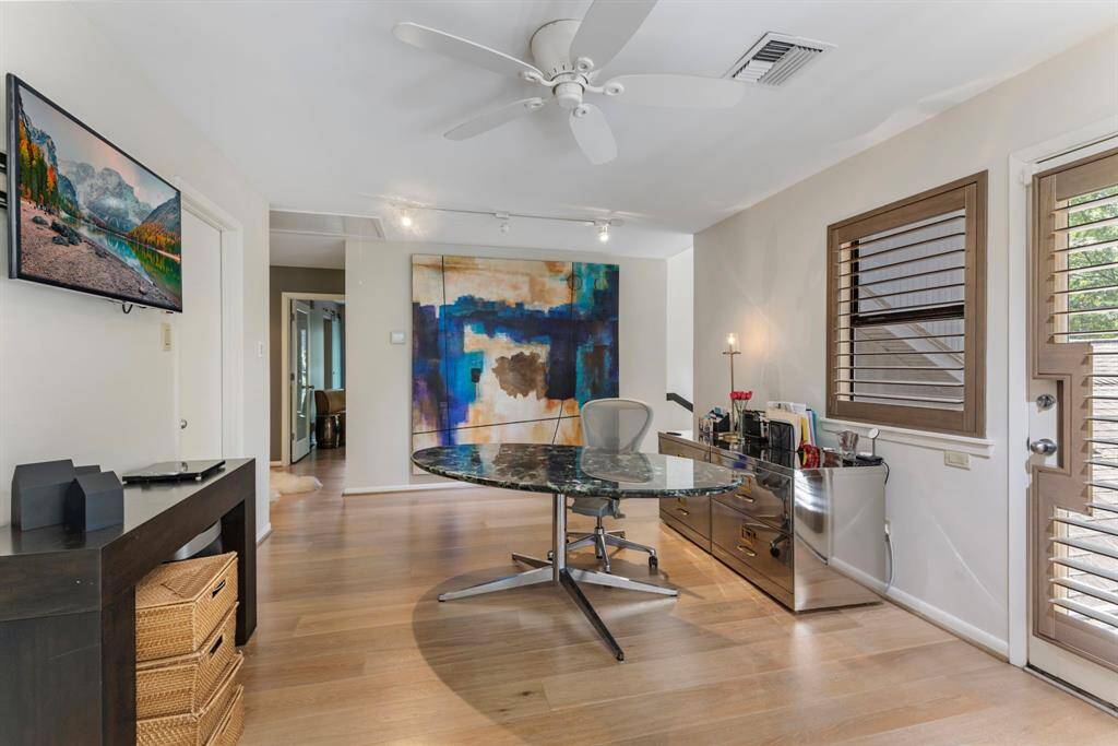 The office affords plenty of room for work and has private access to the outdoor balcony.