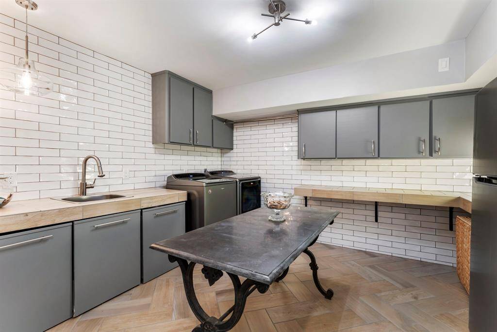 The lower level utility/mud room has generous storage and work space.