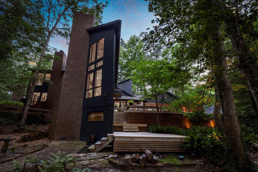 The design of this home blends beautifully into it's natural surroundings. Recent landscape lighting and improvements.