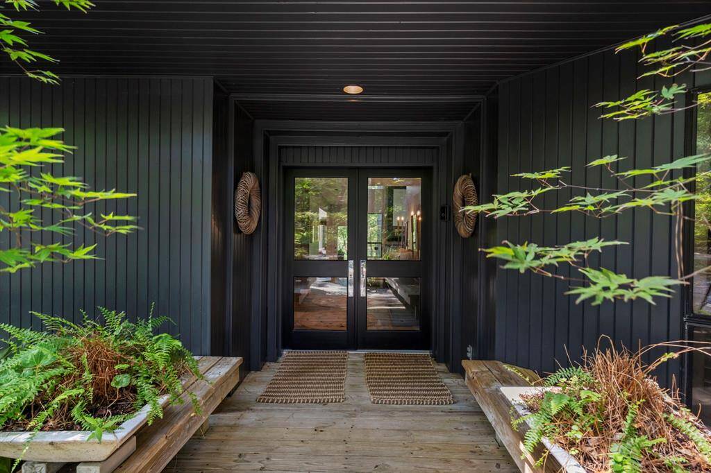 A lush landscape with walking trails, gardens and quiet places to relax or entertain are abundant on just over 5 acres. Welcome to 23414 Holly Hollow Street.