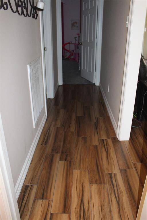 Hall way between bedrooms 1 and 2 showing amazing tile floor.