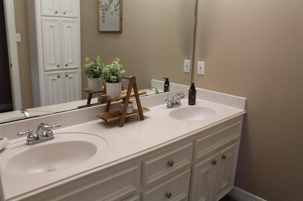 Double sinks in hall guest bath. Lots of storage.