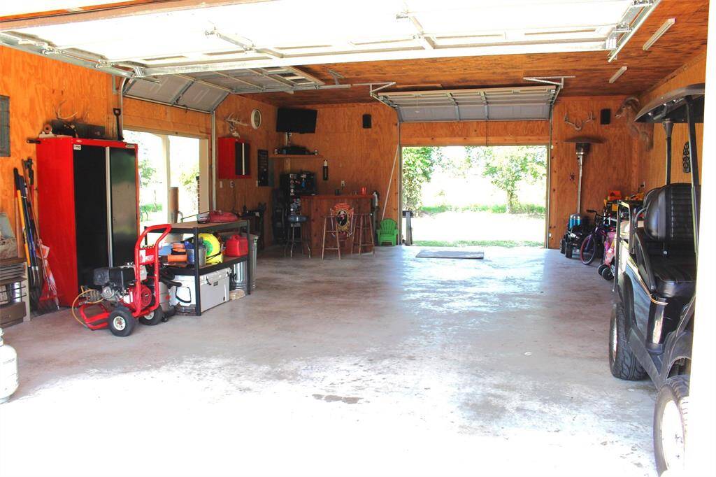 Additional Garage with 3 roll up doors and floored attic.