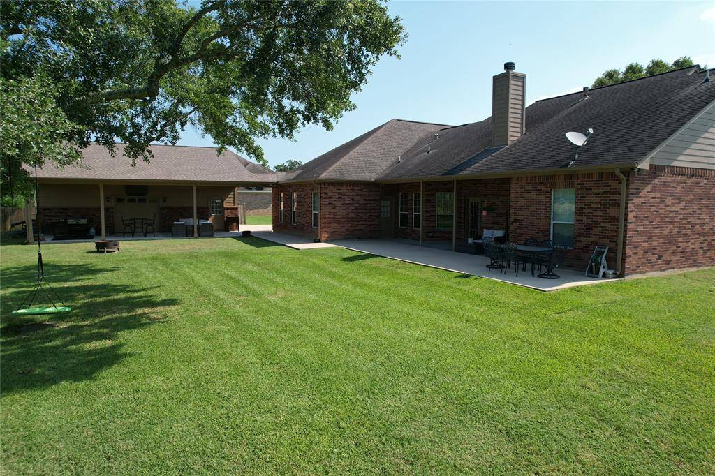 Back Yard with lush grass. Home has a sprinkler system.