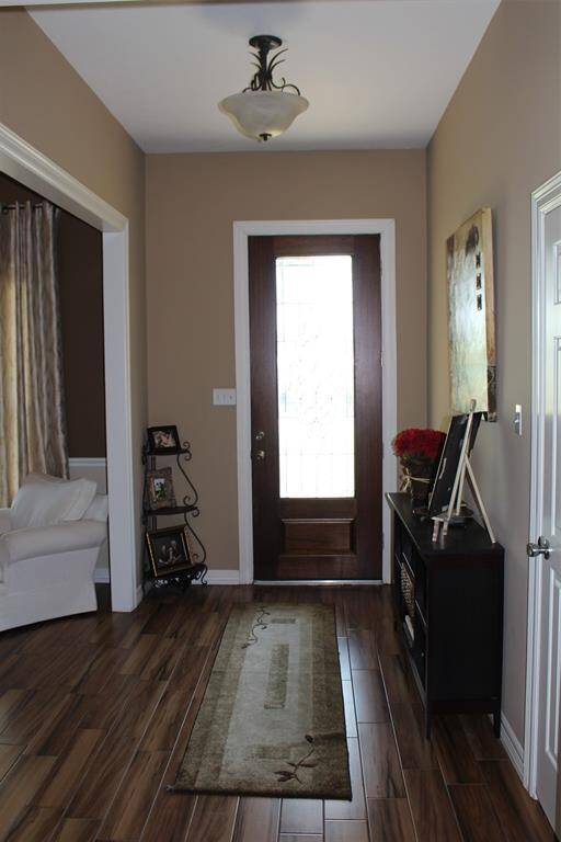 Gorgeous entry with elegant front door. Tons of Natural light.