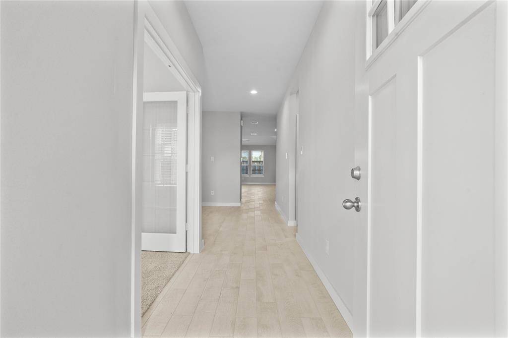 Welcome inside 1951 Scarlet Yaupon Way where you are greeted with this beautiful bright entryway. Featuring wood look tile flooring, custom paint, and recessed lighting!