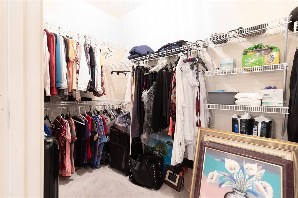 Large Primary walk-in closet with wrap around space.
