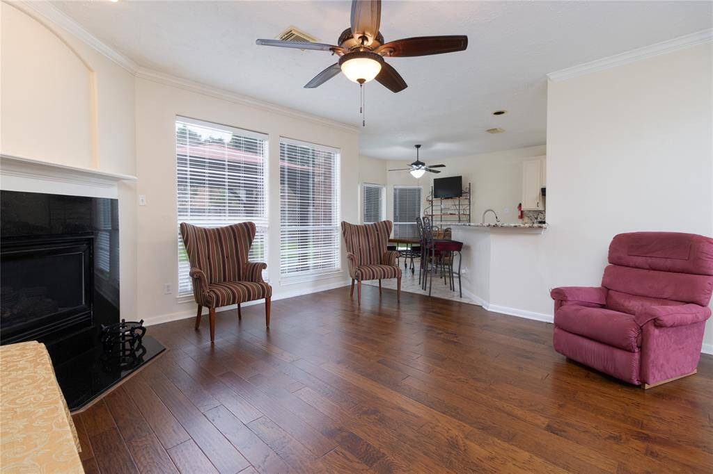 Den that opens up to a dining area and kitchen bar, creating an inviting open floor plan.