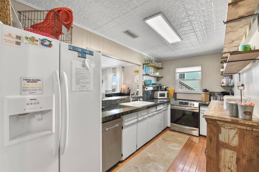 The galley kitchen is so full of charm! The tin ceilings are so much fun!