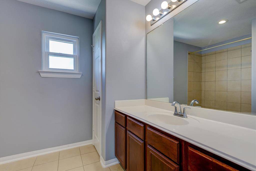 Bathroom has plenty of counter space and large linen closet.