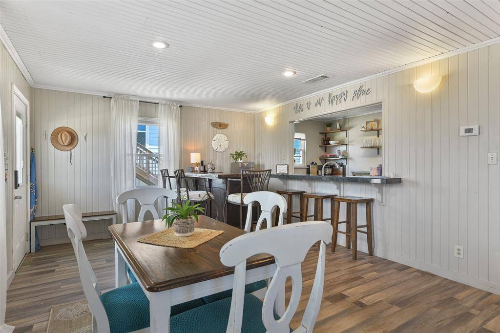 You feel at home in this coastal cottage. The dining space is open to the living area, and bar area!
