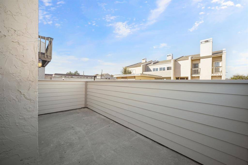 The second floor balcony space is grand and perfect for a sitting area.