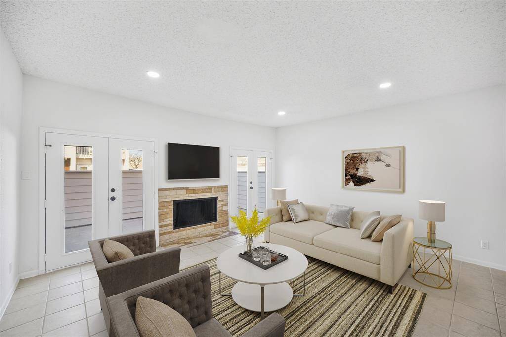 Virtually Staged: This stunning living room features recessed lighting and tile floors, gorgeous fireplace, TONS of natural light and direct access to the patio.