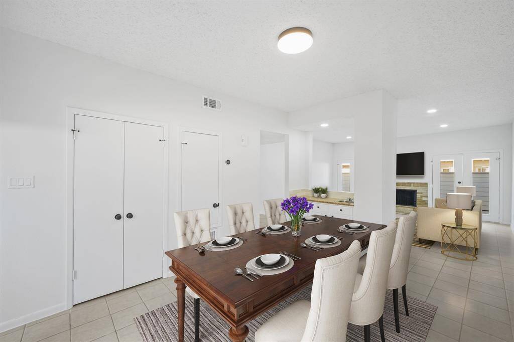 Virtually Staged: Fantastic open layout between the living room and dining room. It includes a wet bar. An entertainer's dream!