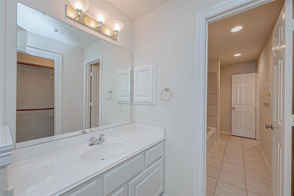 Full bath with separate vanities for bed 3 and 4