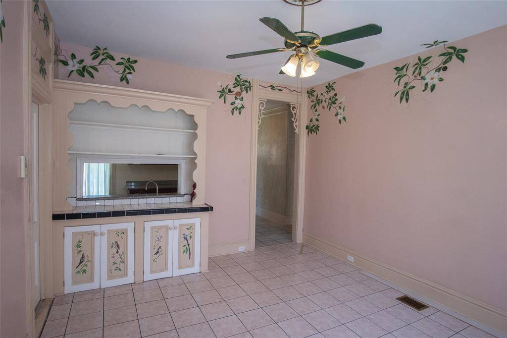 This warm breakfast room features a remarkable serving window to the kitchen with custom built in storage.