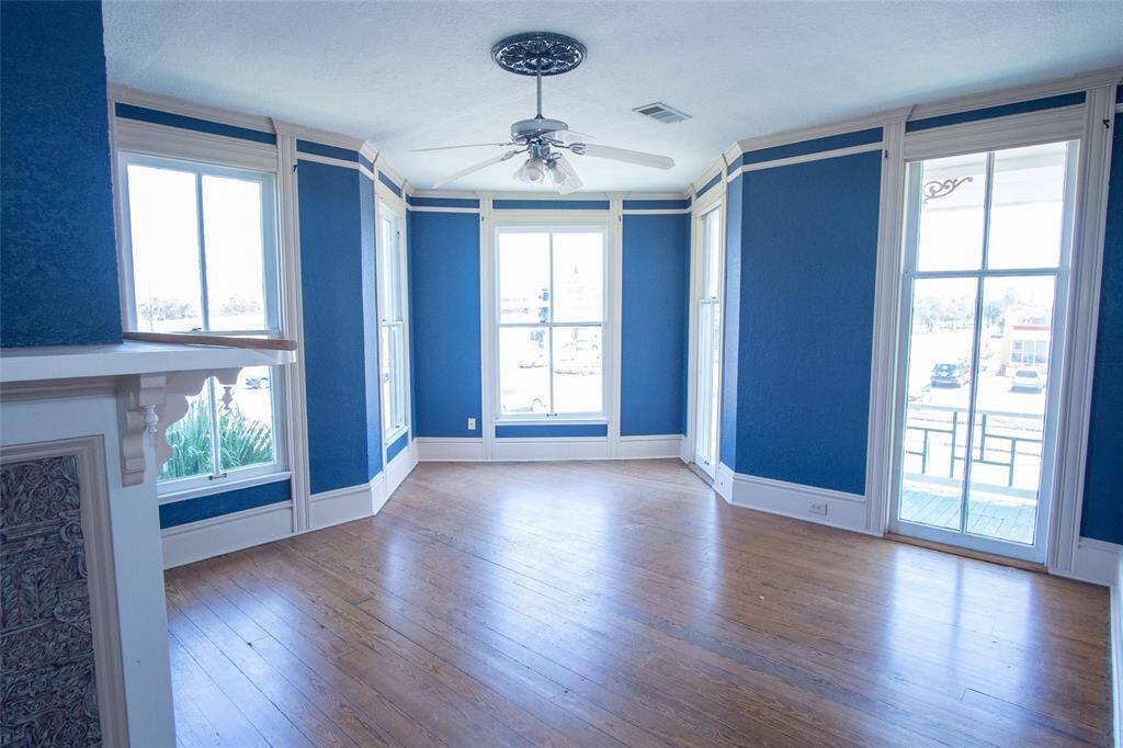 This prominent room would make a great study with detailed molding around the entire ceiling and at the top of the ceiling fan.