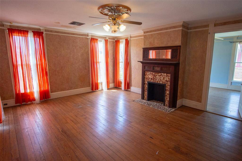 This room offers an embellished mirrored mantel over the fireplace. All 6 of the fireplaces in this historic home are non-working