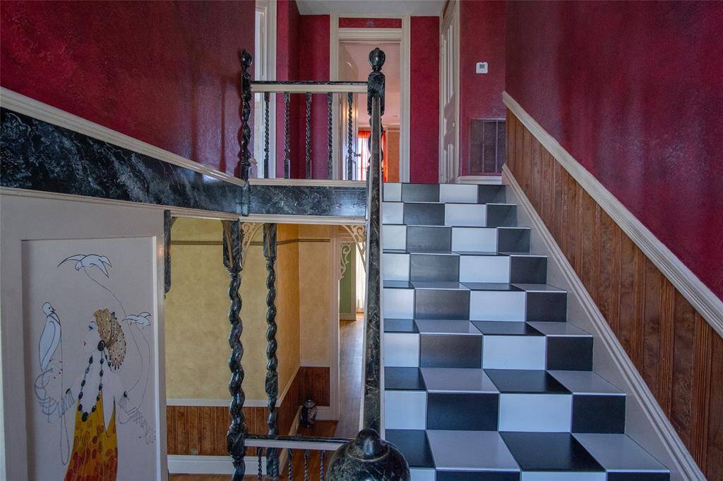 Extraordinary marble railings and exquisite stained glass highlight this staircase.