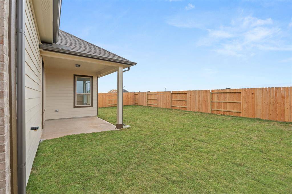 The covered patio is generously sized, providing ample space for various outdoor activities.