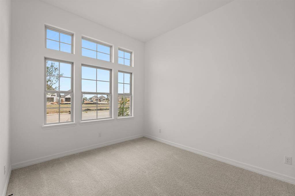Your secondary bedroom features plush carpet, fresh paint, closet, and a large window that lets in plenty of natural lighting.
