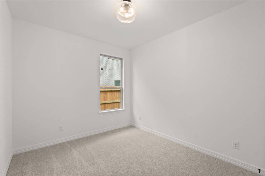 Your secondary bedroom features plush carpet, fresh paint, closet, and a large window that lets in plenty of natural lighting.