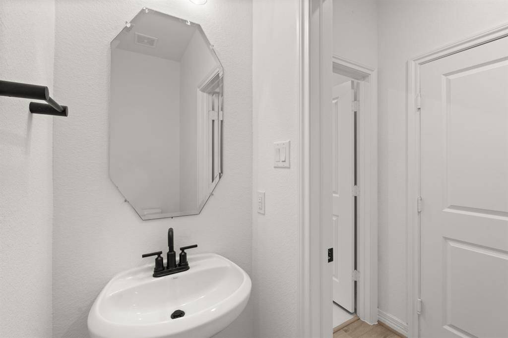 This charming home features a beautifully appointed half bath adjacent to the family room, perfect for welcoming guests and adding convenience to your daily life.