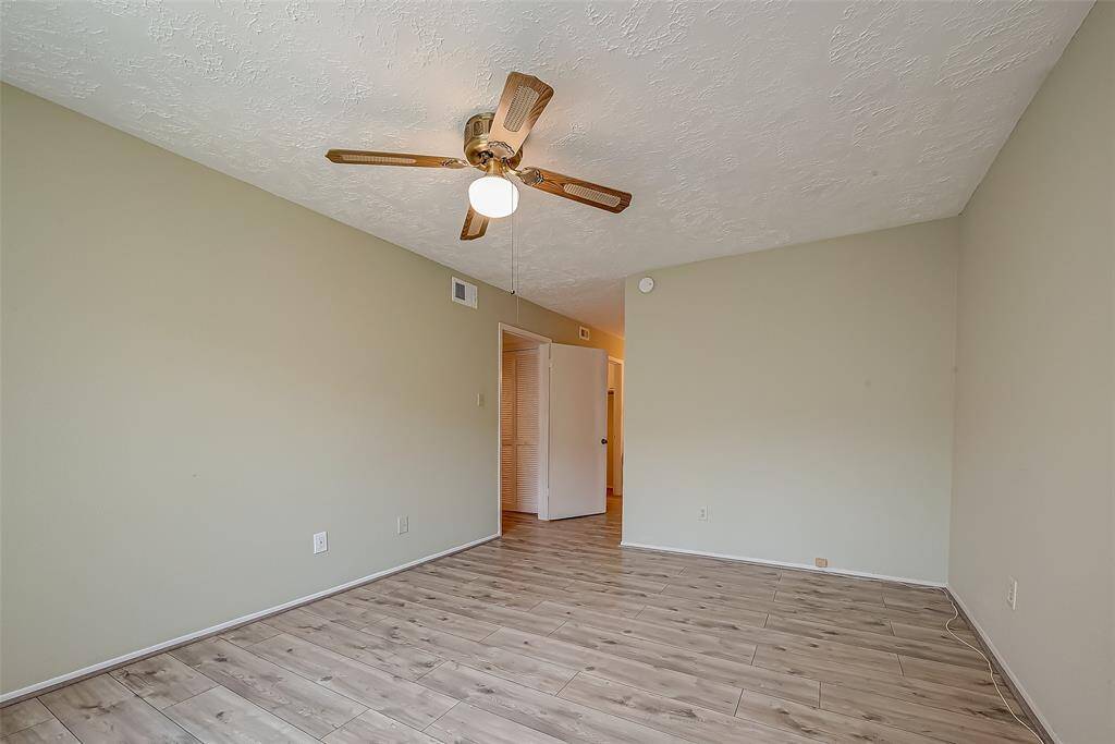Primary bedroom with ceiling fan. and 2 walk-in closets