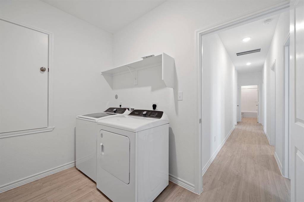 oversized laundry room with move in ready whirlpool washer and dryer