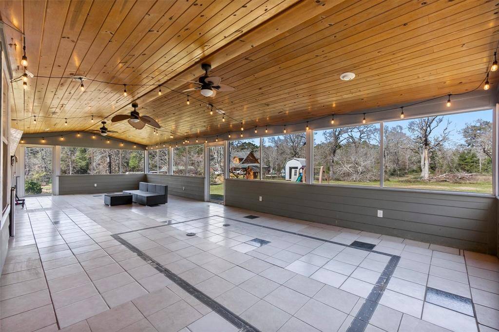 Inviting screened-in porch with stunning views and ample natural light.