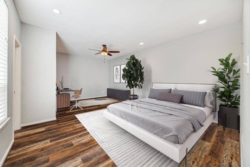 The Downstairs Primary Bedroom is perfectly located off the Dining Room and has ample room for not only a king-size bed, but also a sitting area.  (Virtually staged)