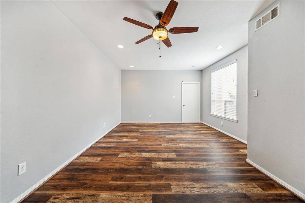 A large window brings in an abundance of natural light from the courtyard area.