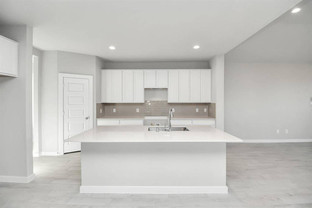 The kitchen is a culinary haven, featuring granite countertops, a tile backsplash, stainlesssteel appliances, and 42” upper cabinets,