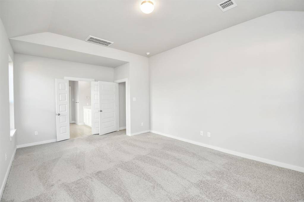 Come and unwind after a long day in this magnificent primary suite! This spacious roomfeatures plush carpet, warm paint, high ceilings and large windows with privacy blinds.