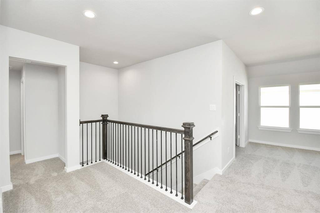 Come upstairs and relish a day of relaxation in this loft area! Ideal as anadditional living space or game room, it boasts plush carpeting, high ceilings,custom paint, and windows that flood the area with abundant natural light.