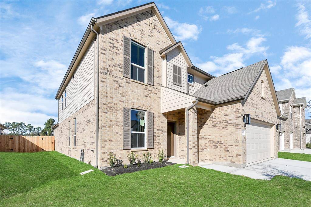 Behold a lush landscape, impeccably maintained yard, and apremium elevation adorned with captivating brick and stone features.